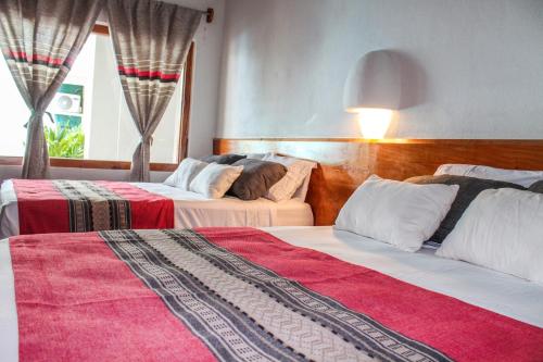Postel nebo postele na pokoji v ubytování Axkan Arte Hotel Tuxtla