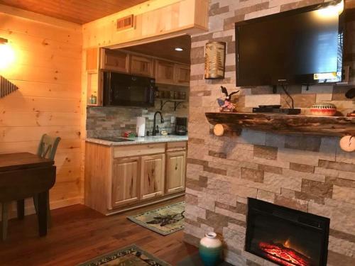 a living room with a fireplace with a tv above it at DreamCatcher Downtown Gatlinburg in Gatlinburg