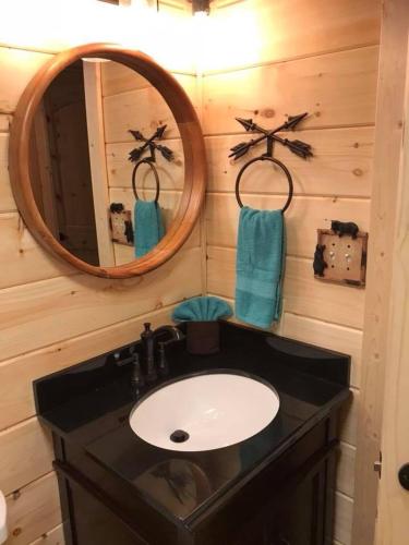 a bathroom with a sink and a mirror at DreamCatcher Downtown Gatlinburg in Gatlinburg