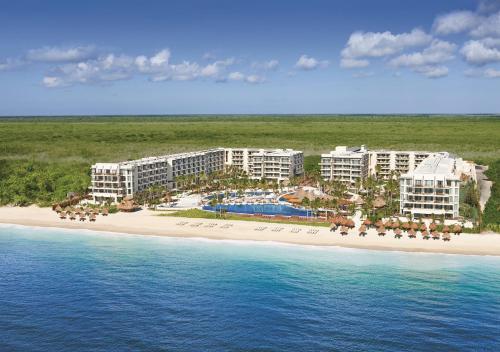 
a beach scene with a large body of water at Dreams Riviera Cancun Resort & Spa - All Inclusive in Puerto Morelos
