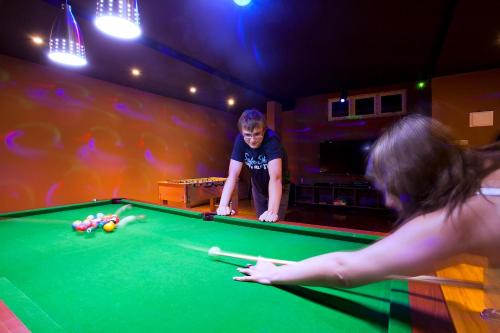 a young boy playing pool in a pool table at Kaani Beach Hotel in Maafushi