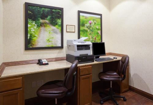 an office with a desk with a computer and two chairs at Country Inn & Suites by Radisson, Minot, ND in Minot