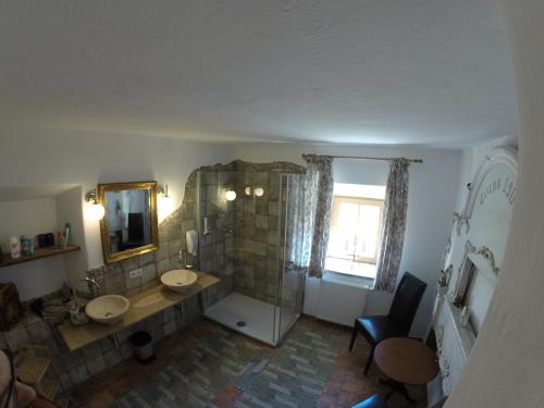 a bathroom with two sinks and a shower with a mirror at Hoamatl in Ebbs