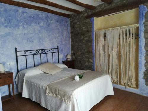 a bedroom with a bed with a flower on it at Casa el Francés in Graus