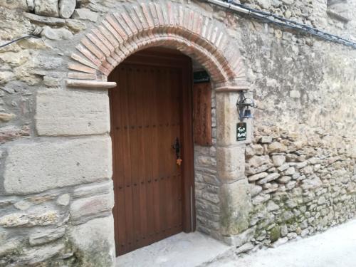an entrance to a stone building with a wooden door at Casa el Francés in Graus