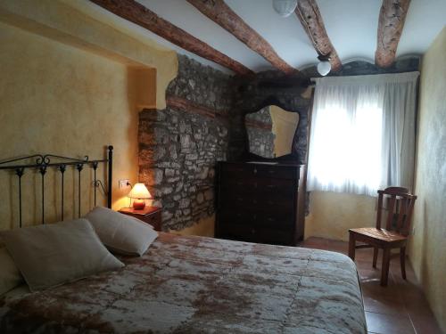 a bedroom with a large bed and a window at Casa el Francés in Graus