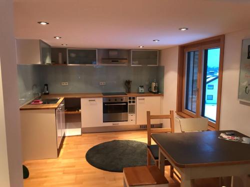 a kitchen with a table and a dining room at Haus Marie in Alberschwende