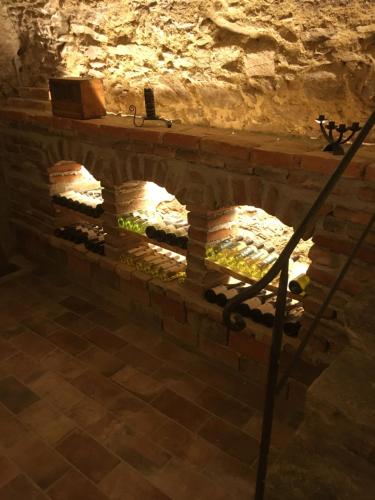 a wine cellar in a cave with a stone wall at Pension Sunnseitn - Gasthof - Café - Weinkeller in Haslach an der Mühl