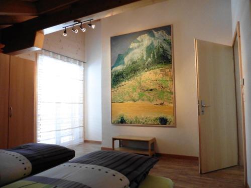 a bedroom with a painting hanging on the wall at Laubrinus in Adelboden