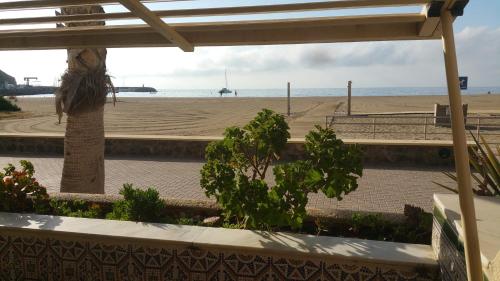 uma vista para a praia a partir do alpendre de uma casa de praia em Apartamento SOLYMAR 3 em San José