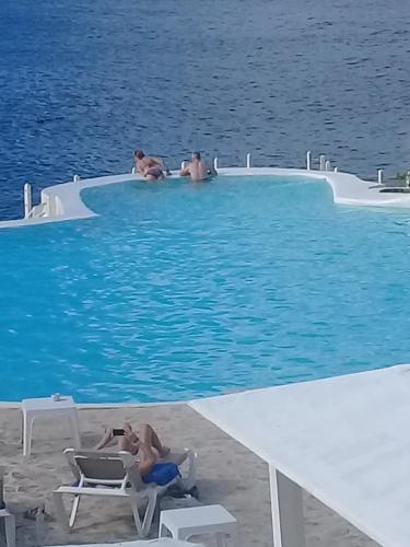 a group of people sitting in a swimming pool in the water at Habitacion en Sol Dominicus solo adultos in Bayahibe