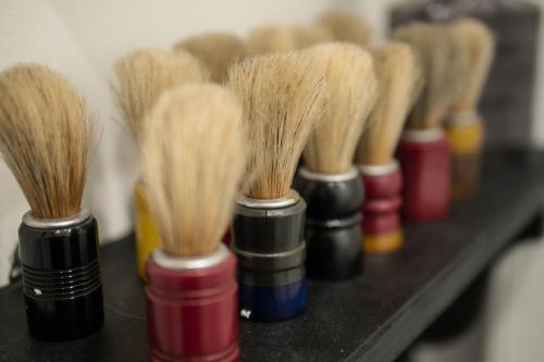 a row of different colored brushes on a shelf at Family Affair Luxury Rooms&Suites in Palermo