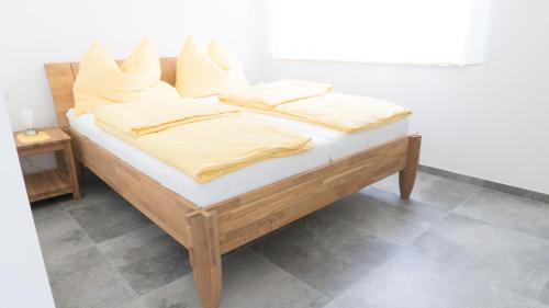 a bed with white sheets and pillows on it at Kogelschneiderhof in Dobl-Zwaring
