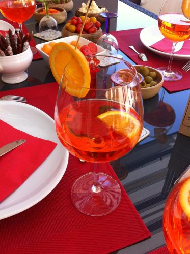 a wine glass with an orange slice on a table at Junior Suite Le Pied de Mulet in Brouchaud