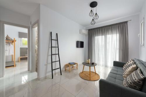 a living room with a ladder and a couch at L & C Boutique Apartments in Kremasti