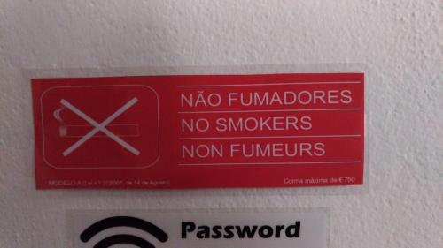 a red sign on the ceiling of a room at Route 2 Torrão in Torrão