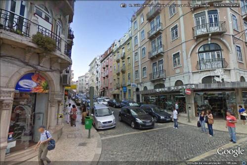 a busy city street with cars parked on the street at Sweet House in Lisbon