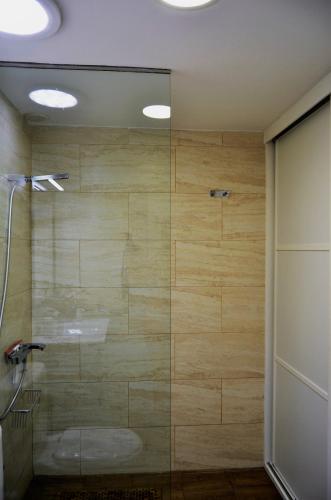 a shower with a glass door in a bathroom at Bungalow ACK in Playa del Ingles