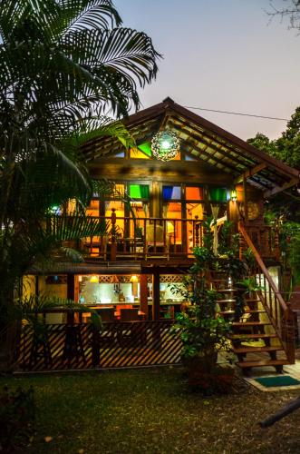 a house with a lit up facade at night at Rice Barn And Rooms in Hang Dong