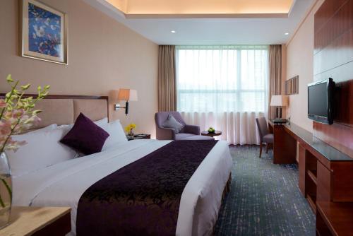 Cama o camas de una habitación en Sentosa Hotel Shenzhen Majialong Branch