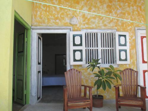 two chairs and a plant in a room at Sithila Villa in Mount Lavinia