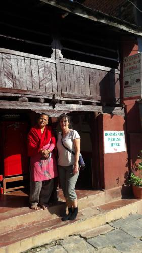 two people standing in the doorway of a building at kayastha restaurant & lodge in Bandīpur