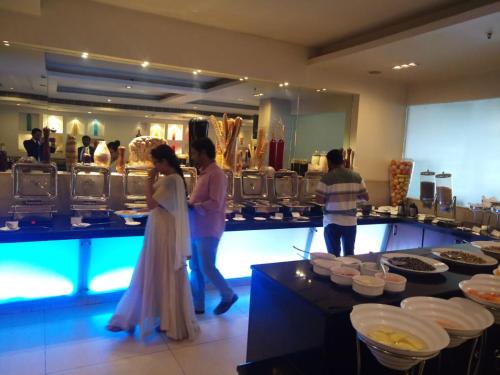a bride and groom standing in front of a buffet at Hampshire Plaza in Hyderabad