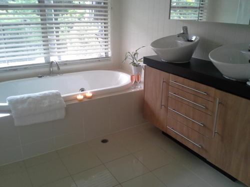 a bathroom with a bath tub and a sink at Stay @ LP Montville in Montville