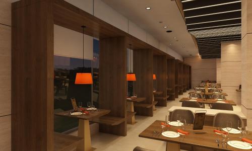 a dining room with wooden tables and chairs at Sayaji Vadodara in Vadodara