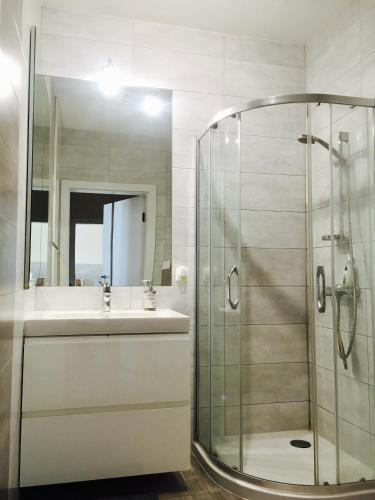 a bathroom with a shower and a sink at ClickTheFlat Artistic Estate Apartment in Warsaw