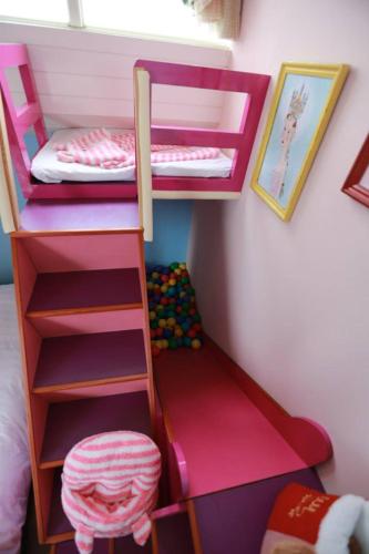 a play room with two bunk beds and a ladder at Travel Light in Jiaoxi