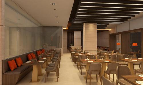 a restaurant with wooden tables and chairs and a cafeteria at Sayaji Vadodara in Vadodara