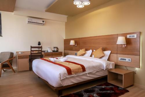 a bedroom with a large bed and a desk at Retro Hotel and Spa in Kathmandu
