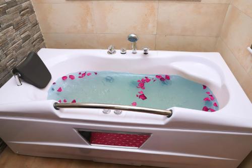 a white bath tub with flowers in it at Retro Hotel and Spa in Kathmandu