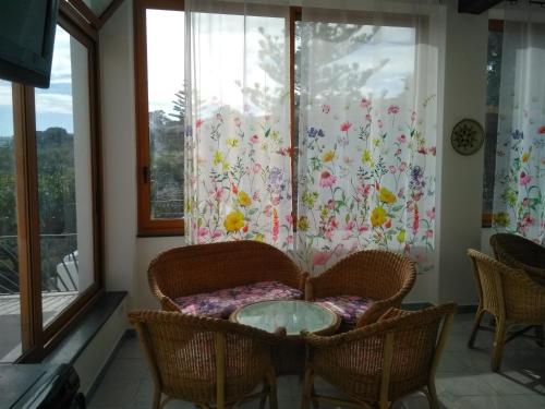 a room with a table and chairs and a window at Villa Petrusa in Stromboli