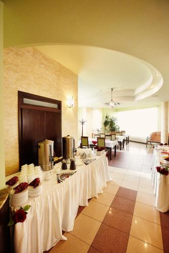 a banquet hall with tables with white table cloth at Hotel Dukat in Biała Podlaska