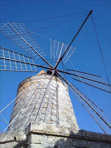 a large windmill sitting on top of a building at B&B MaryJosè in Trapani
