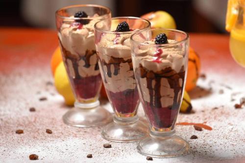 two glasses of ice cream sundaes on a table at Sokoterme Hotel in Soko Banja