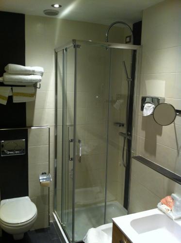 a bathroom with a shower with a toilet and a sink at Hotel Piccolo Lido in Bordighera