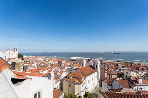 a view of a city with buildings and the ocean at Alfama Loft Studio Loft Apartment w/ River View - by LU Holidays in Lisbon