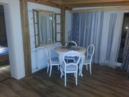 a room with a table and chairs and a mirror at Gasthaus Joó-Wellness Pension in Rábapaty