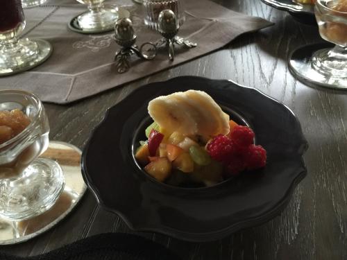 a bowl of food with fruit on a table at B&B les Agapanthes in Gasny