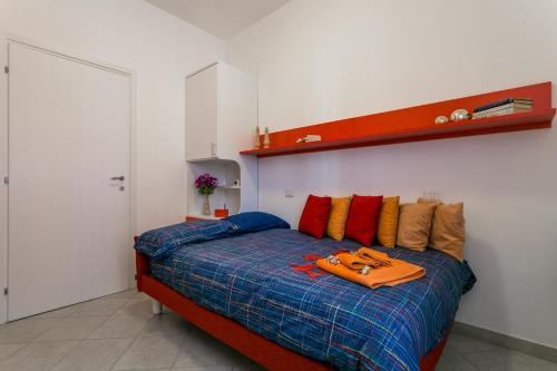 a bedroom with a bed with an orange bag on it at Park House Niguarda in Milan