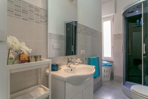 a white bathroom with a sink and a shower at Park House Niguarda in Milan