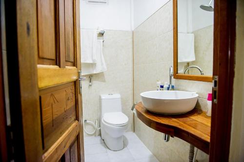 a bathroom with a white sink and a toilet at Detour Beach View in Hangnaameedhoo