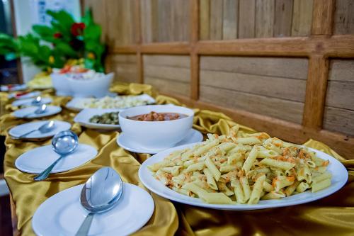 a table with plates of food and bowls of dips at Detour Beach View in Hangnaameedhoo
