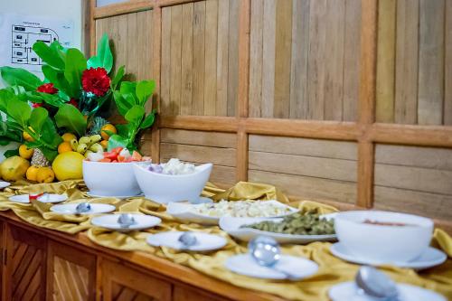 a table topped with bowls and plates of food at Detour Beach View in Hangnaameedhoo