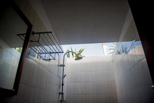 a shower in a bathroom with a window at Detour Beach View in Hangnaameedhoo
