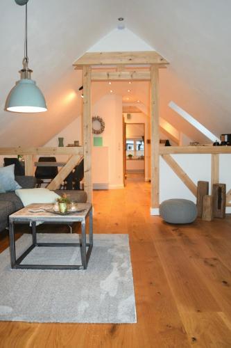 a living room with a couch and a table at Ferienwohnungen Schneider in Lennestadt