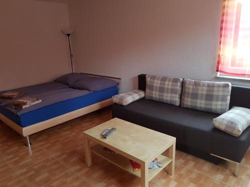 ein Wohnzimmer mit einem Bett und einem Sofa in der Unterkunft Ferienwohnung Katharina in Ettenheim